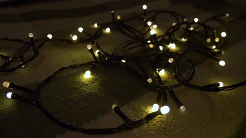 Closeup Shot Hank of Christmas Garland with Golden Lights on a Playd