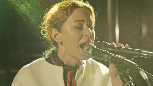 Singer Performing Live on Stage at Night
