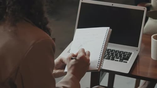 Business Woman Making Notes in Copybook