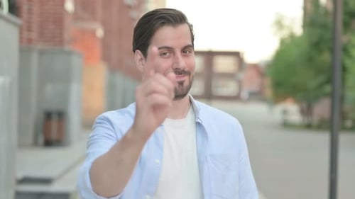 Smiling Man Invites Viewer with Hand Gestures