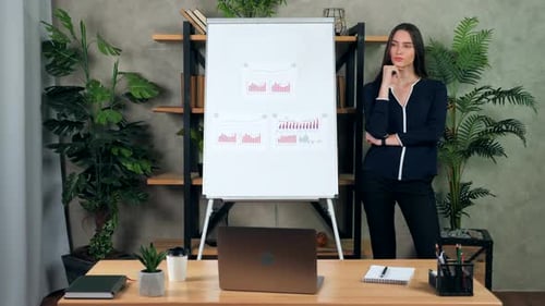 Young Woman Presents Business Data in Modern Office