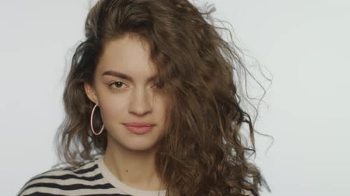 Woman with Curly Hair Posing in Studio
