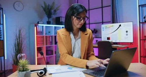Woman Working on Laptop in Modern Office