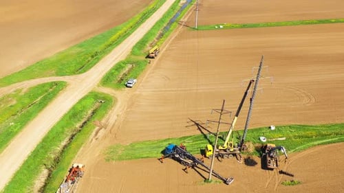 Aerial View of Heavy Equipment Working on Powerlines