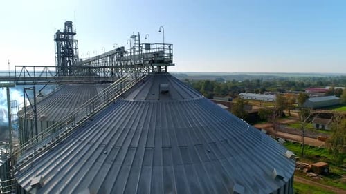 Metal elevator for crop. Silo for storing grain in the countryside. Exterior of large storage tanks