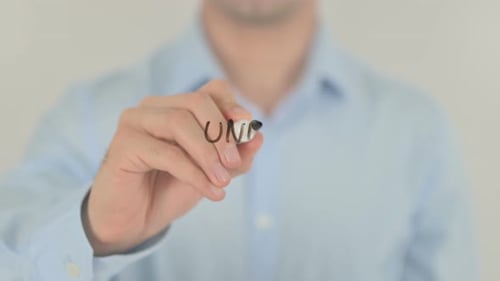Hand Writing 'Under Maintenance' on Clear Surface
