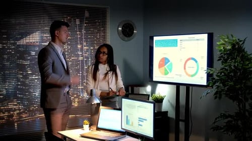 Business Man and Business Woman Analyzing Company Growth Depicted on Infographic