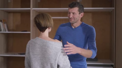 Man and Woman Embracing Affectionately Indoors