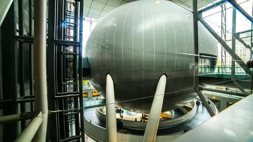 Modern Building Interior with Spherical Structure and People