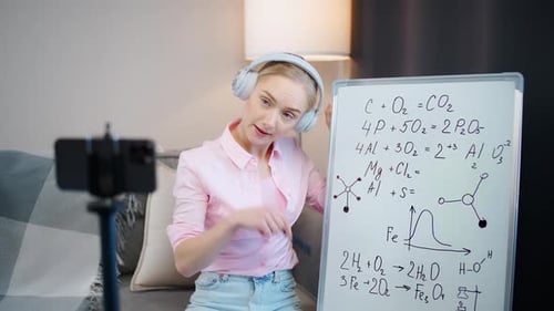Young Adult Explains Chemistry Equations with Marker