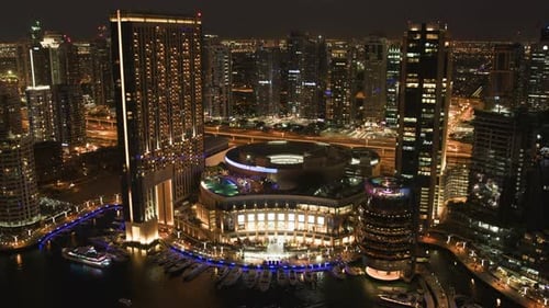 Modern Building Near Water and View of the City Lights at Night