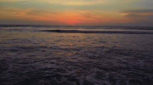 Flight at Sunset Overlooking the Indian Ocean in Bali Indonesia
