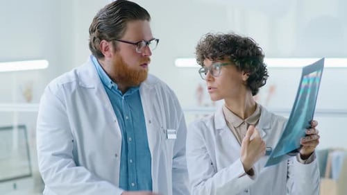 Doctors Reviewing X-Ray in Modern Office
