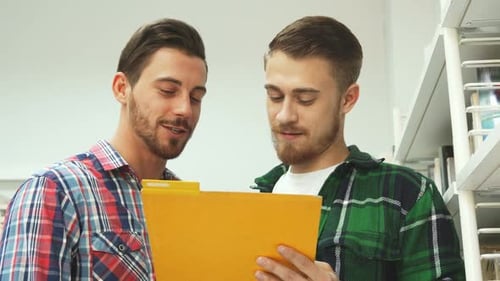 Young Adults Reviewing Documents Together