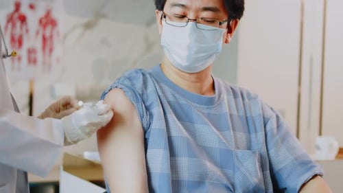 Adult Receiving Vaccine in Clinic, Medical Shot