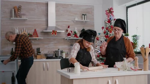 Cheerful Family Baking Christmas Cookies Together in Kitchen