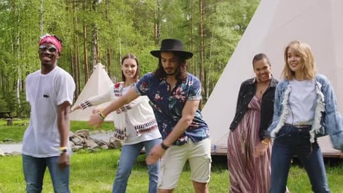 Happy Friends Dancing Together Outdoors in Summer