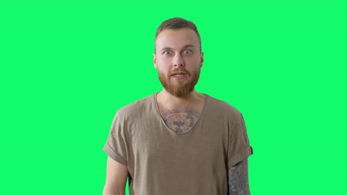 Serious Handsome Man on Chroma Key. Confident Surprised Bearded Tattooed Hipster
