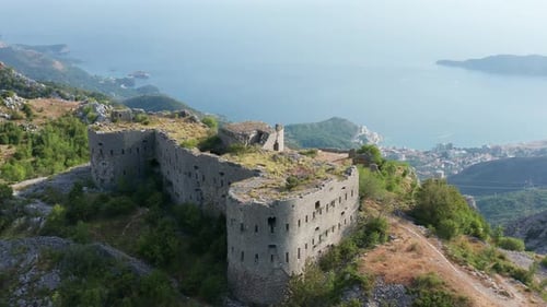 Ruin of an old stone fortress on the top of the hill, overlooking the coast and sea