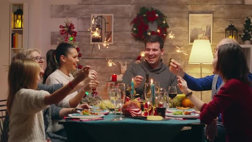 Family Celebrates with Sparklers at Holiday Dinner