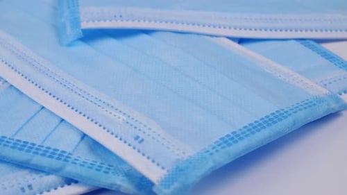 Medical blue masks slowly rotating and prevention concepts for coronavirus and viral disease.