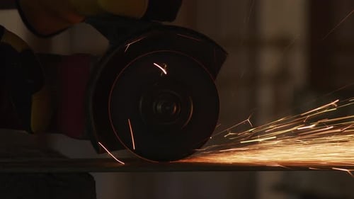 Worker Cutting Metal with Angle Grinder