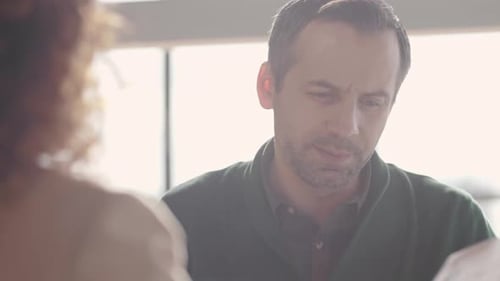 Man Explaining Finances in Business Meeting