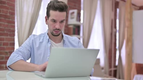 Ambitious Young Man Working on Laptop