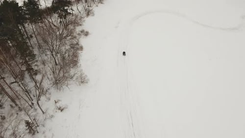 ATV Ride Across a Snowy Winter Landscape