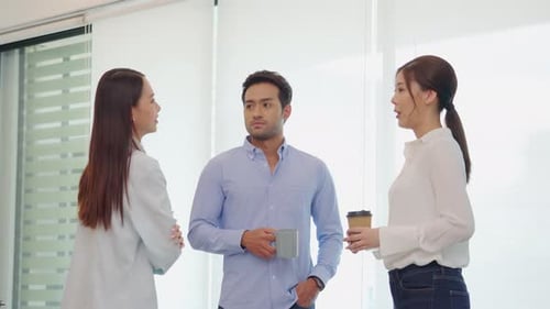cheerful young Business Team Coffee Break holding coffee cups and talking Relax at the office