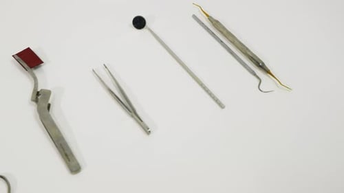 Sterile Dental Instruments Displayed on White Surface