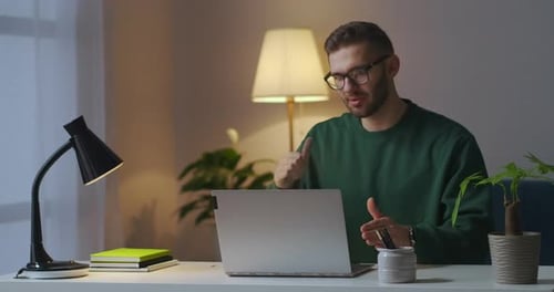 Man Video Conferencing At His Desk