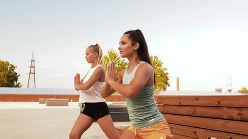 Women Doing Lunges Together on Rooftop Deck
