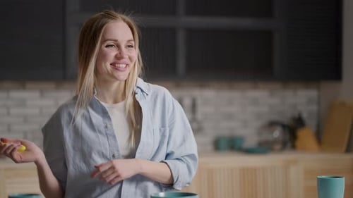 Woman Dancing with Whisk in Kitchen