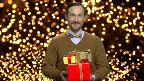 Man Holding Stack of Christmas Gifts and Smiling