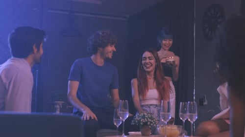Friends Celebrate Birthday With Cake Indoors at Night