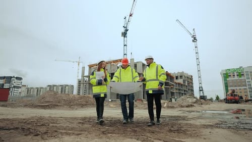 Foreman Architect and Civil Engineer are Walking in Building Site Viewing Plan on Paper and