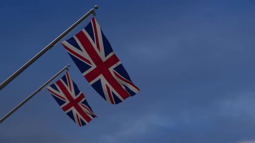 Waving United Kingdom Flags Against a Blue Sky