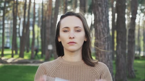 Pandemic Covid-19 coronavirus protection, Woman puts on protective medical face mask on street