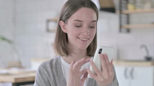 Portrait of Young Woman Using Smartphone in Office