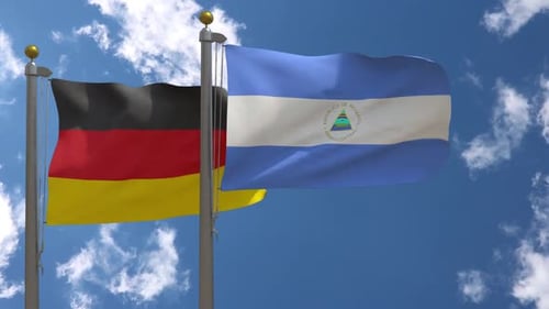 Germany and Nicaragua Flags Waving Together in Blue Sky