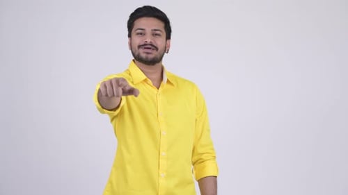 Young Happy Bearded Indian Businessman Pointing at Camera