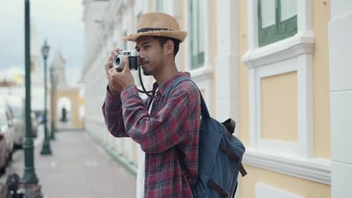 Young Adult Tourist Taking Pictures in City