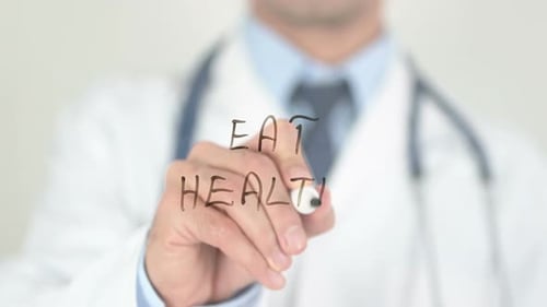 Doctor Writes 'Eat Healthy' On Clear Surface