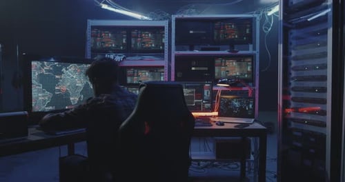 Hacker Watching Multiple Monitors