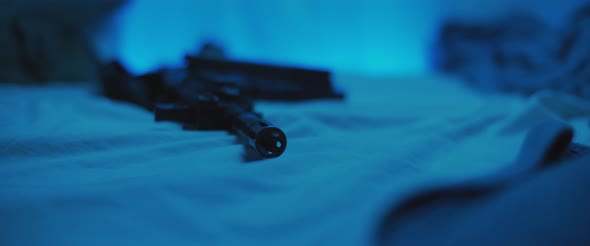 Close up of M16 rifle lying on a bed. Military, PTSD soldier concept ...