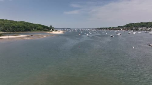 A low angle view of the Northport Marina on Long island, NY with several anchored boats. It is a sun