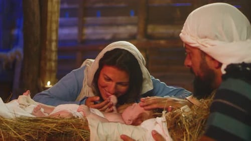 Mary and Joseph Kissing and Touching Baby Jesus