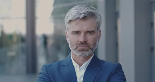 Confident Mature Man Stands in the City