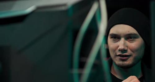 Man Works at Computers in Dark at Night